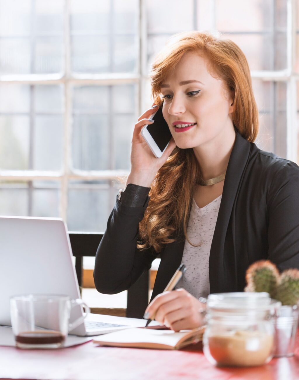 Young woman talking over the phone Young woman talking over the phone in bright glazed office
